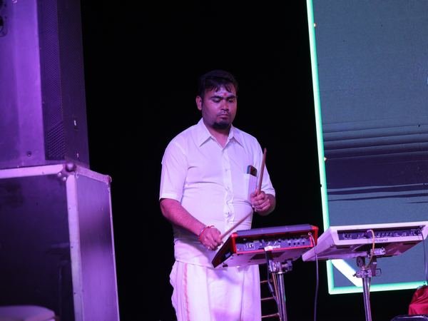 A musician playing an octapad on stage at a music programme at Amartarangini, Haridwar